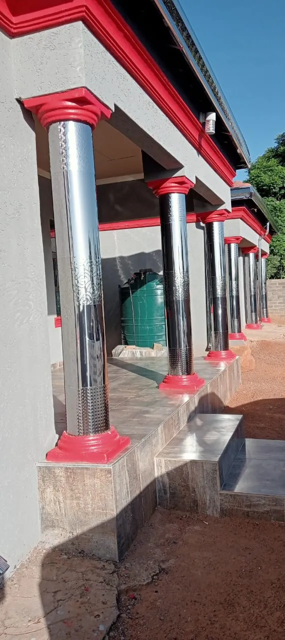 Row of veranda pillars covered in polished stainless steel cladding