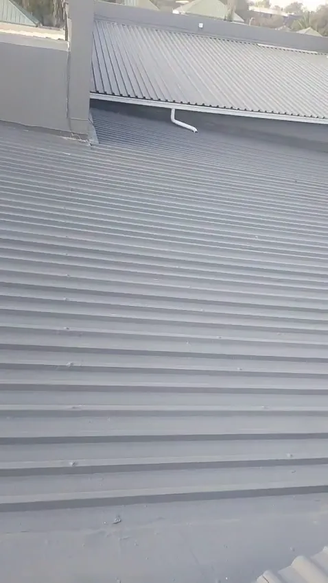 Metal sheet roof freshly painted grey