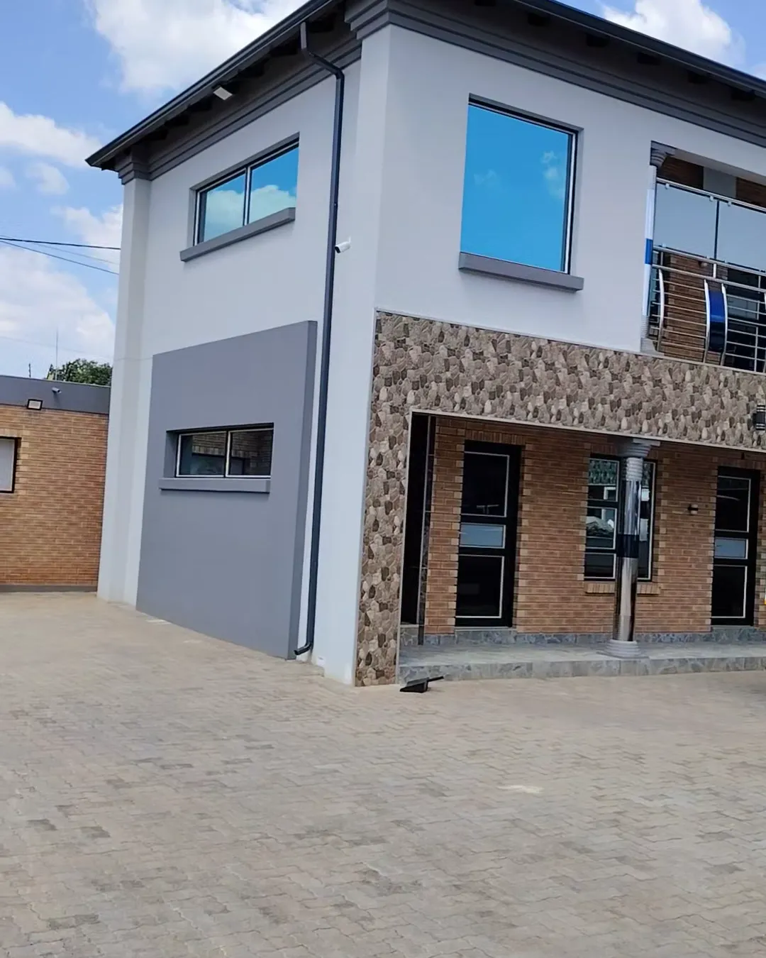 Double-storey commercial building with gutters, downpipes and aluminium windows